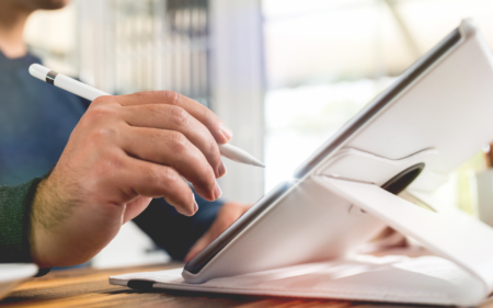 man signing a tablet