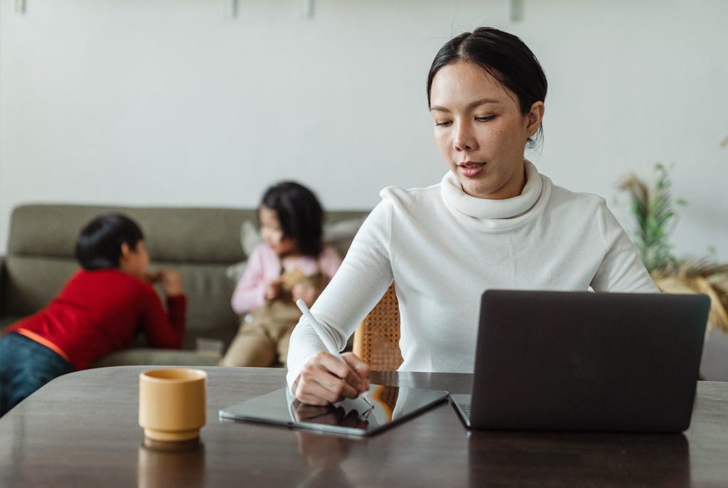 woman working from home with kids playing
