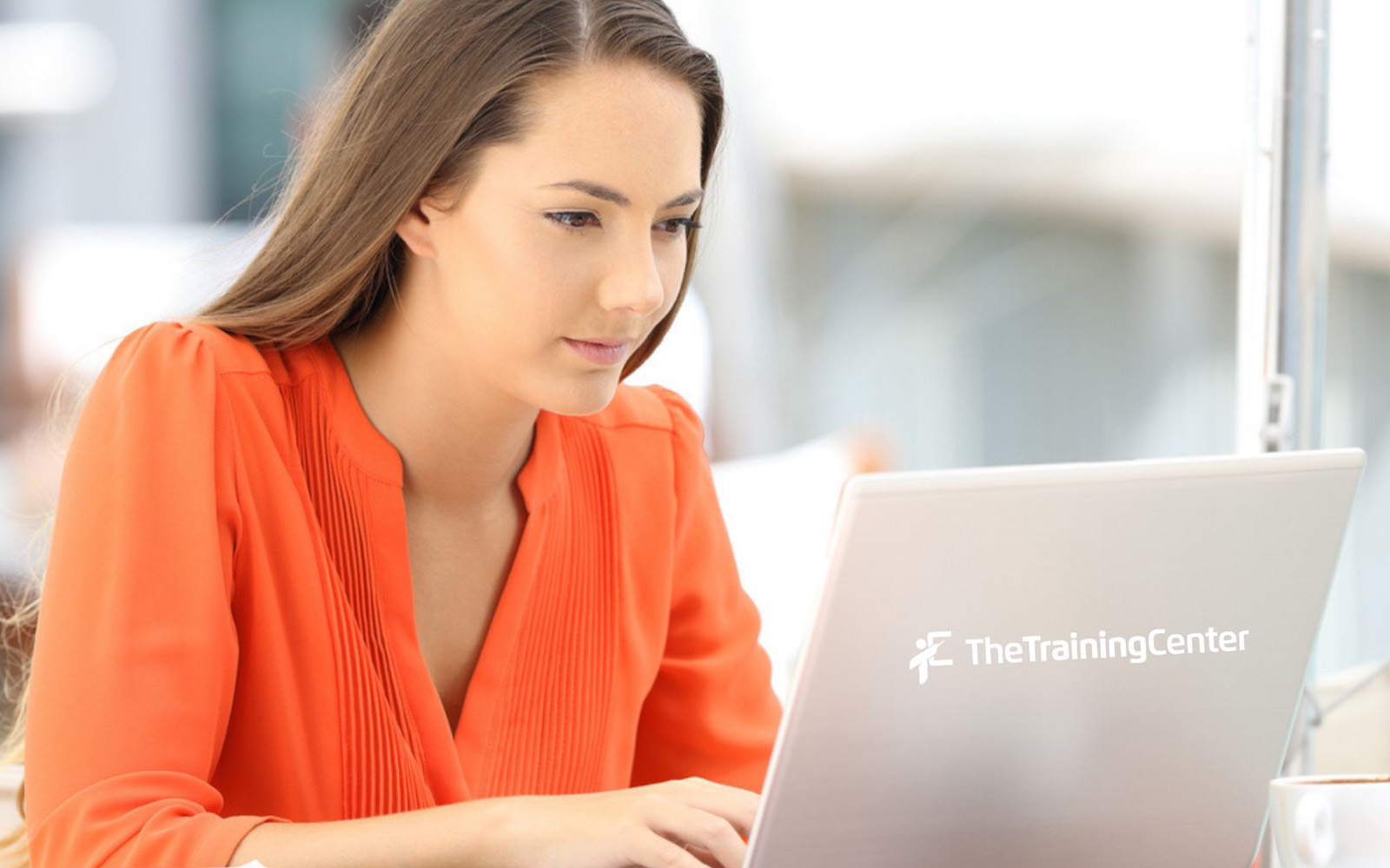 focused woman using a laptop training
