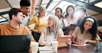 students crowded around a teacher