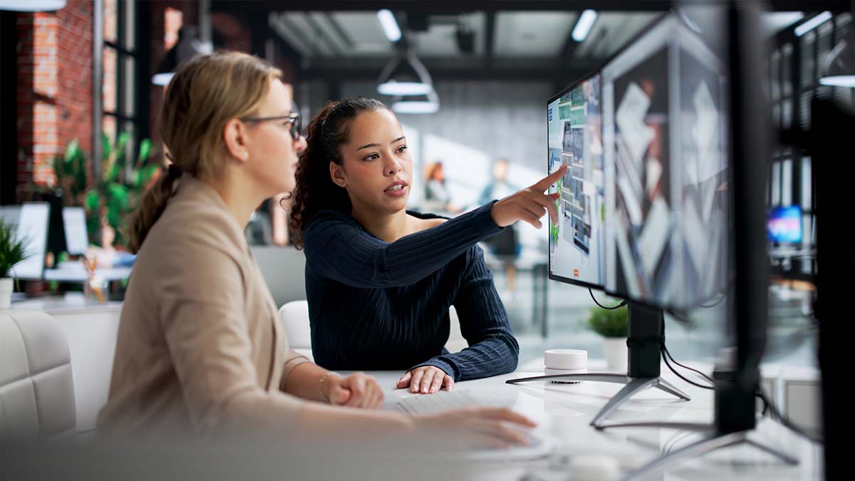 employees reviewing data on a screen