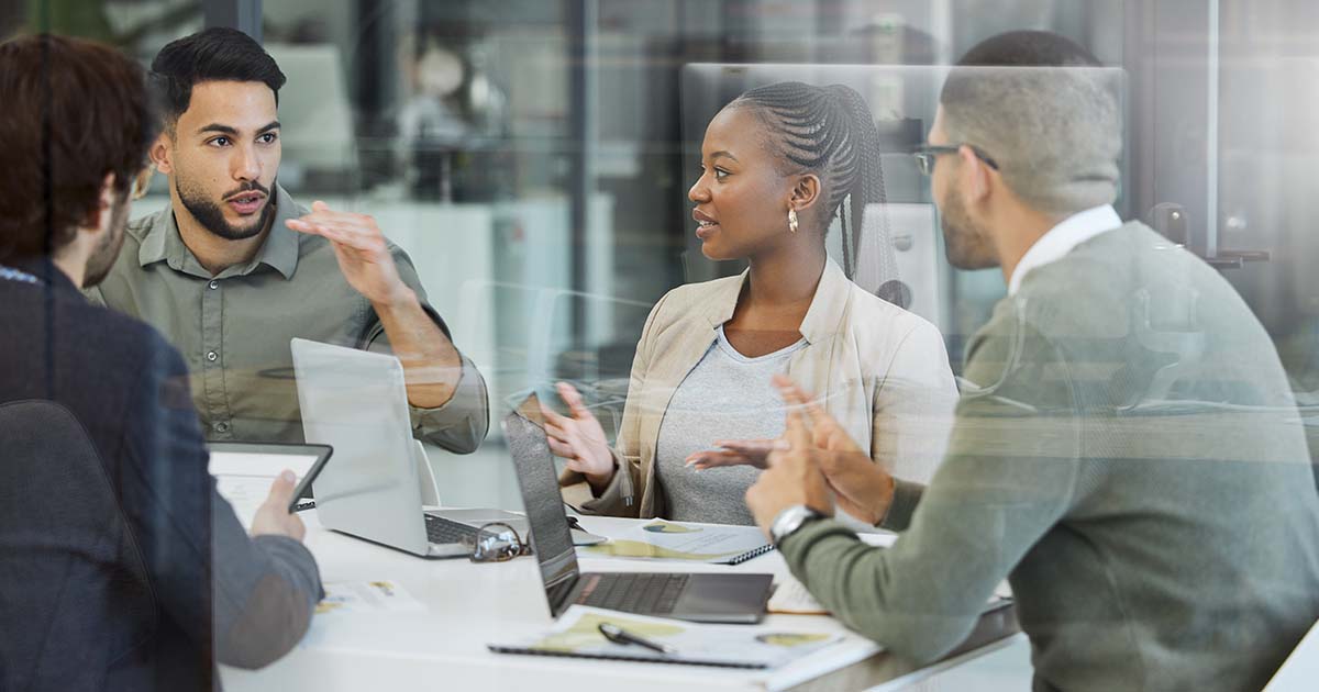 people in discussion while working together
