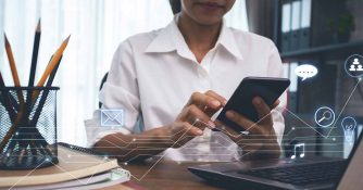 woman working from home on multiple devices