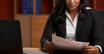 How Davie County Automated Contract Approvals client story image of lady holding paper contracts