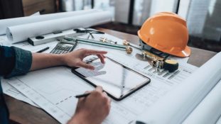 engineer working with permit software on tablet