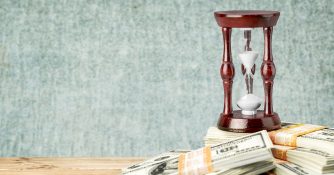 hour glass and stacks of money